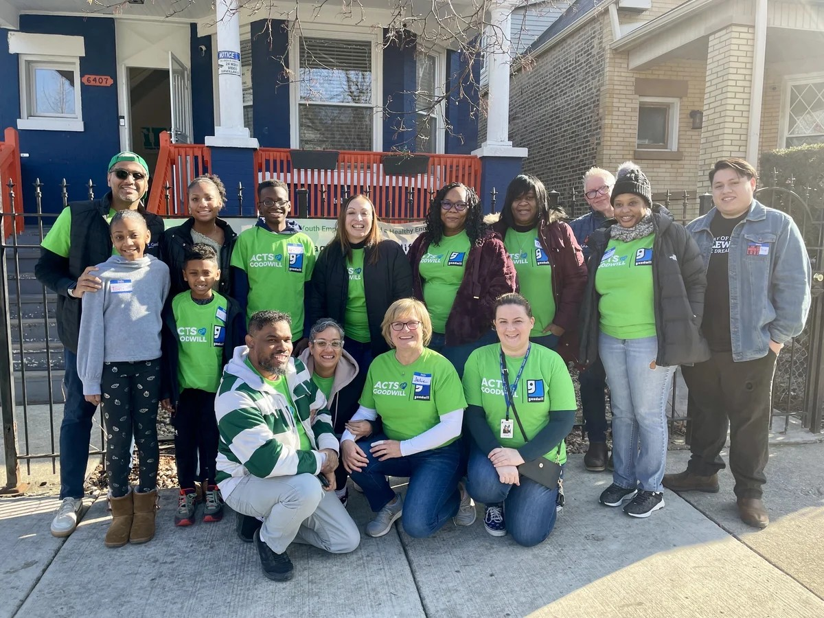 goodwill volunteers in front of house
