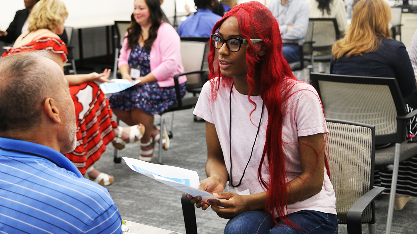 A Goodwill career coach gives interview tips to a teen searching for a job