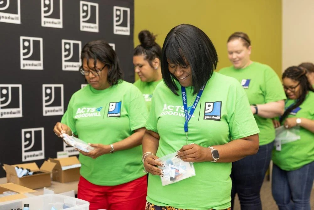 goodwill volunteers packing kits