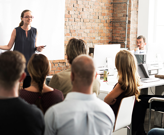 Speaker at head of room in front of audience
