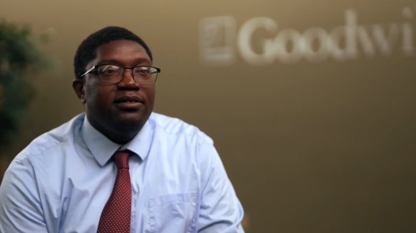 man in front of goodwill logo