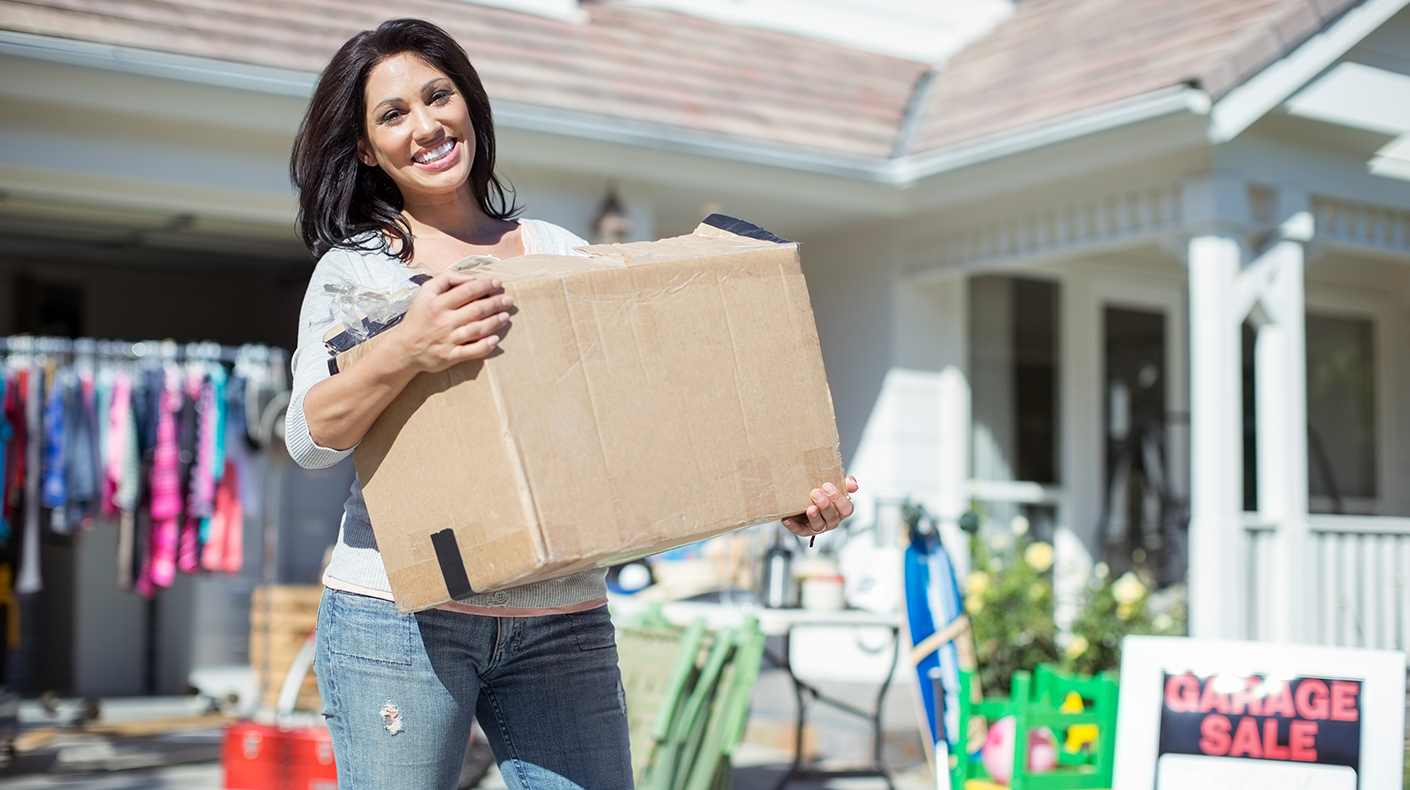 woman with box of donations from garage sale