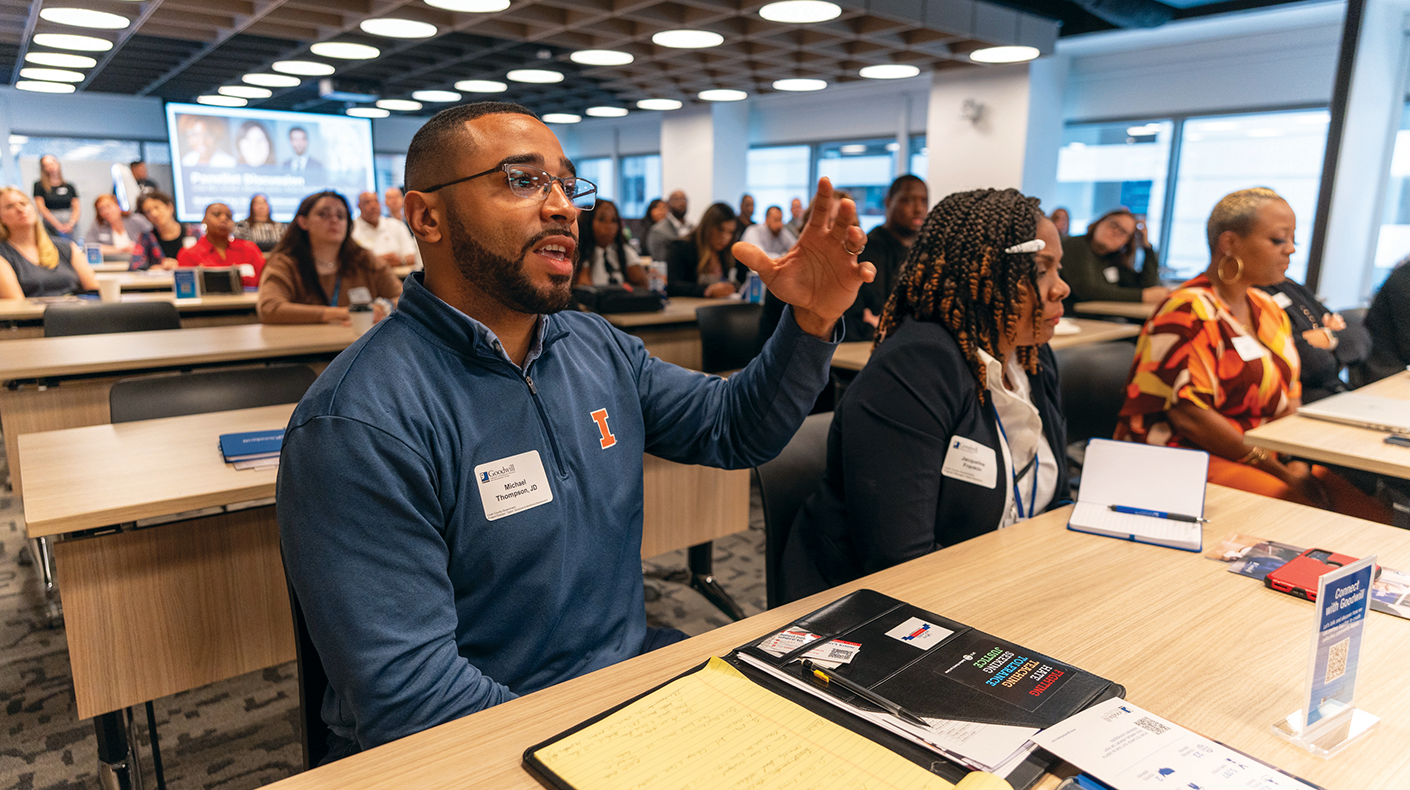 man raising hand in a classroom style event