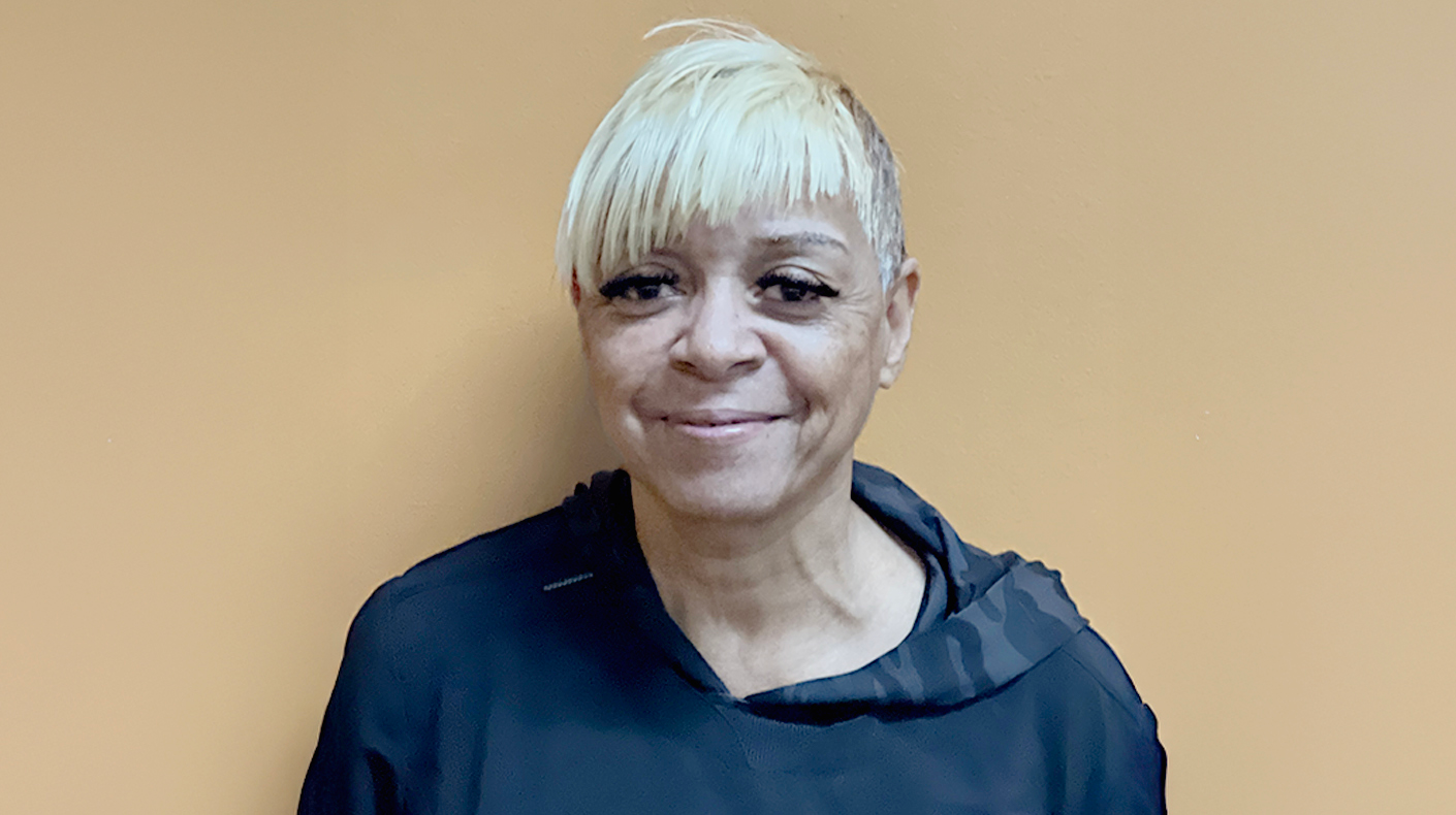 Woman standing in front of a neutral background