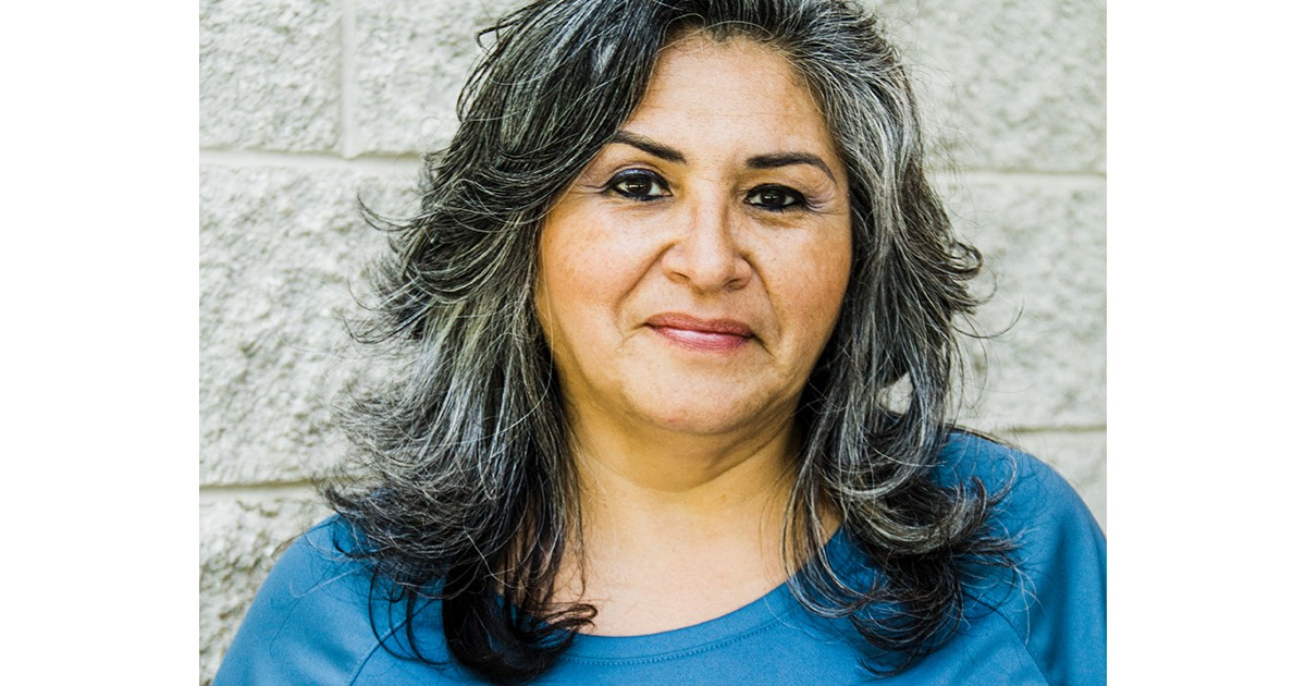 goodwill employee in front of brick wall