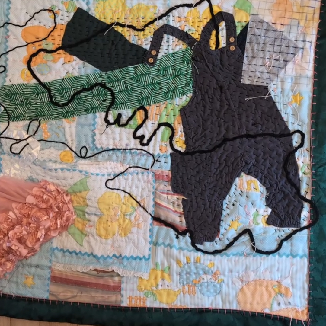A hand-crafted quilt displaying baby blankets and unique stitching