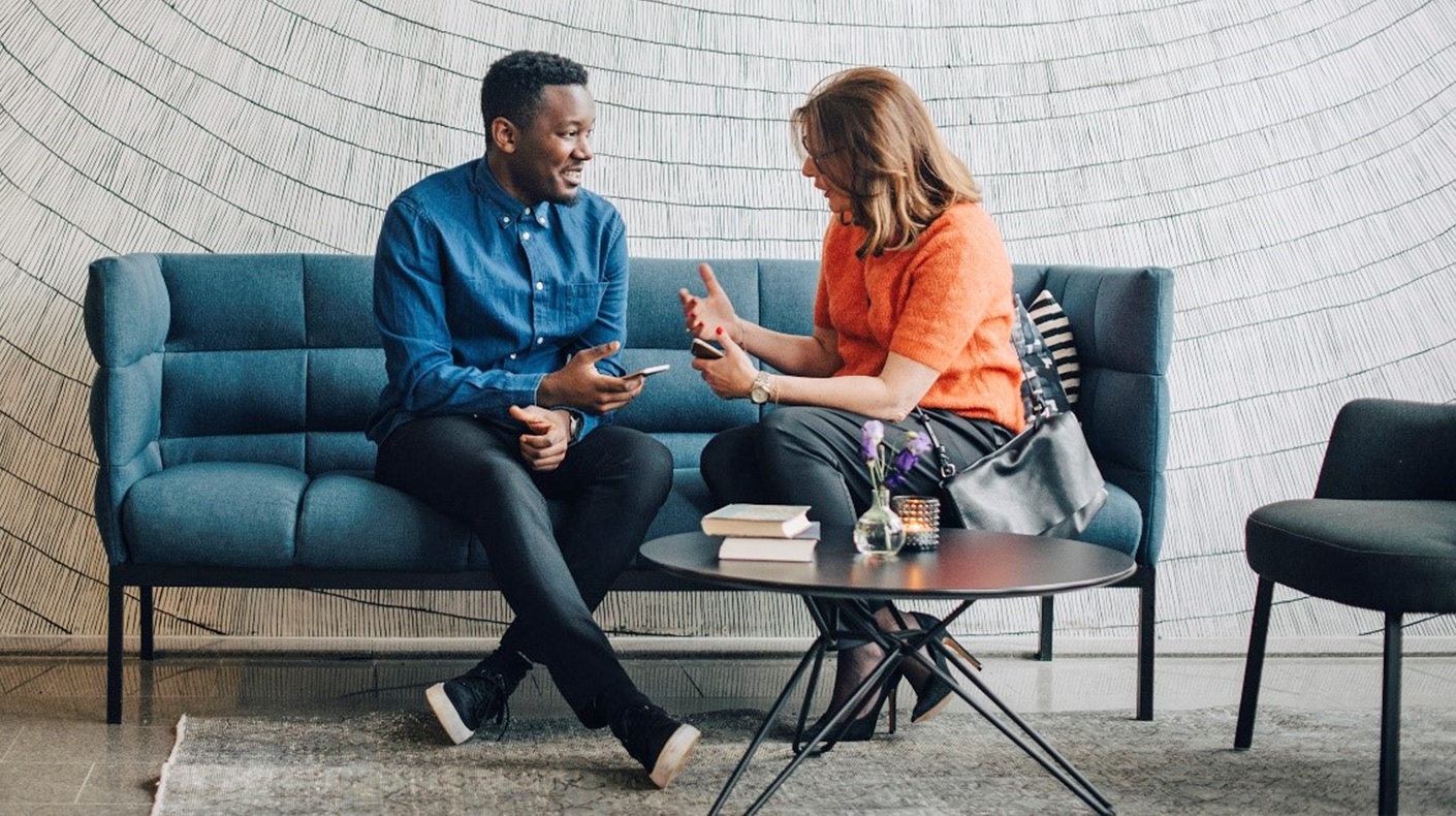 man and woman on couch talking