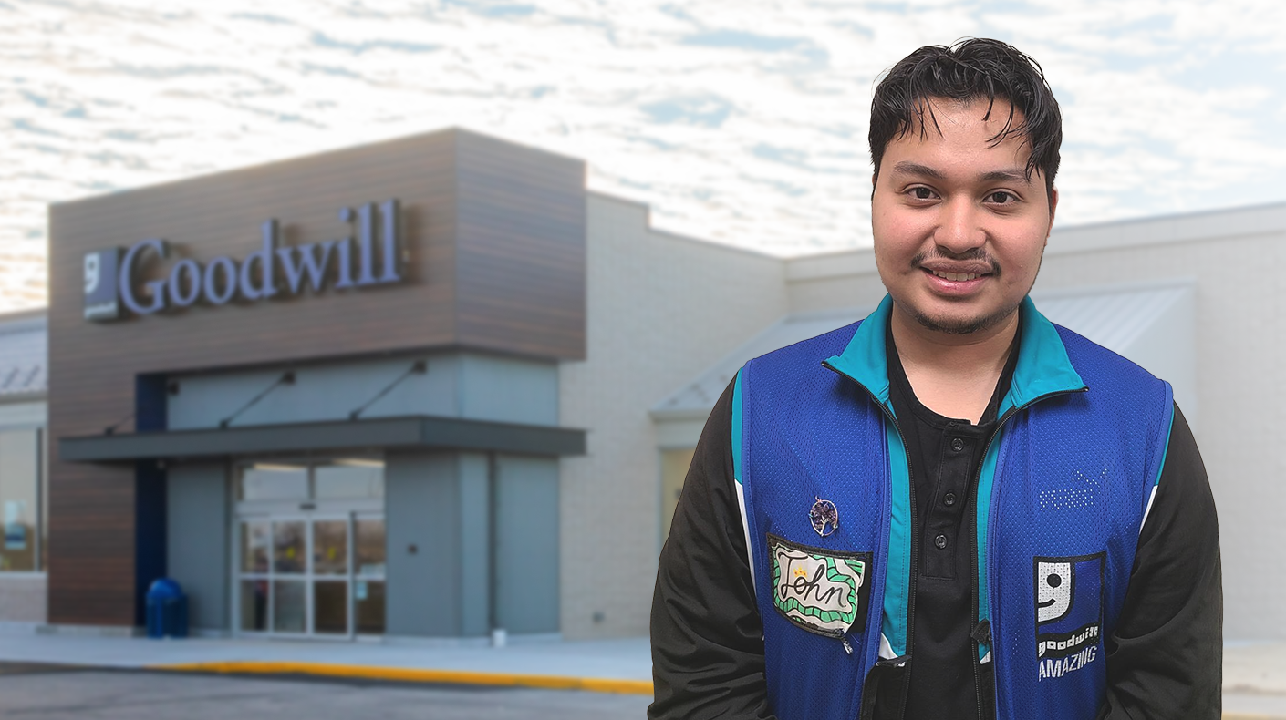 goodwill store employee in front of store