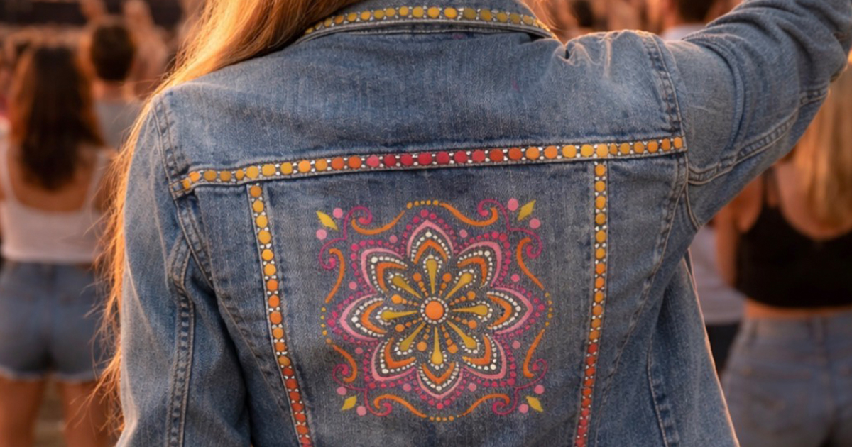 Close up of a colorful dot painted design on the back of a denim jacket