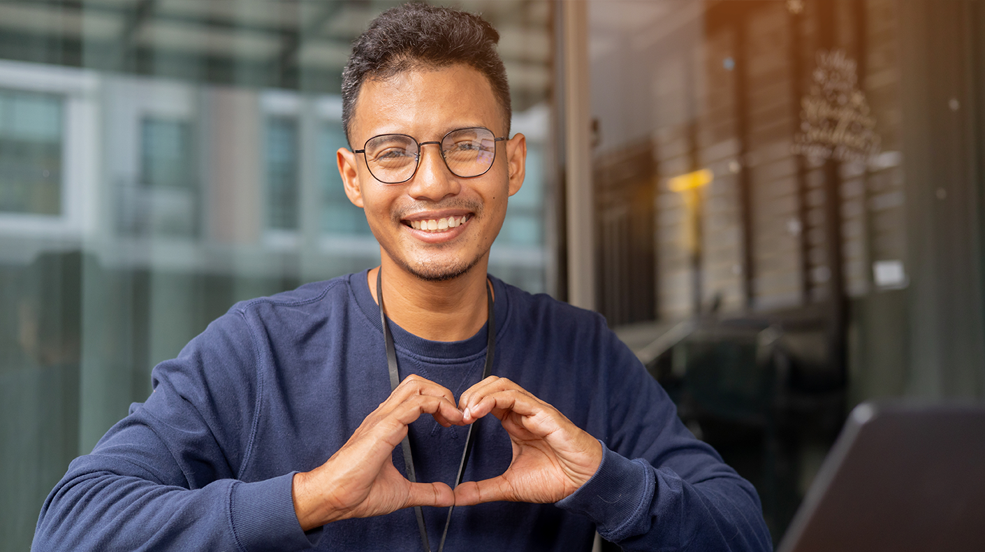 young man making heart hands