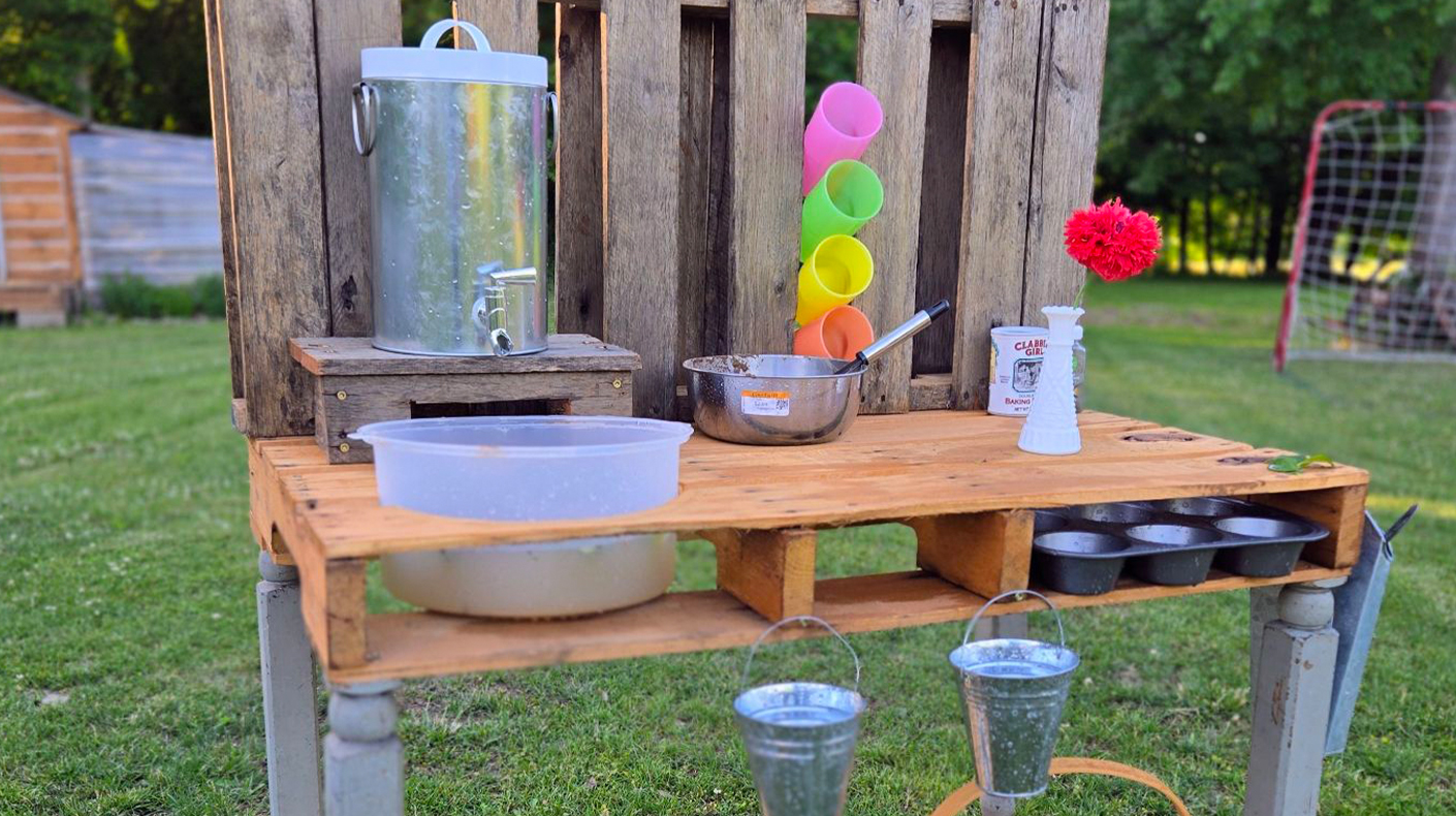 A handmade mud kitchen with thrifted items