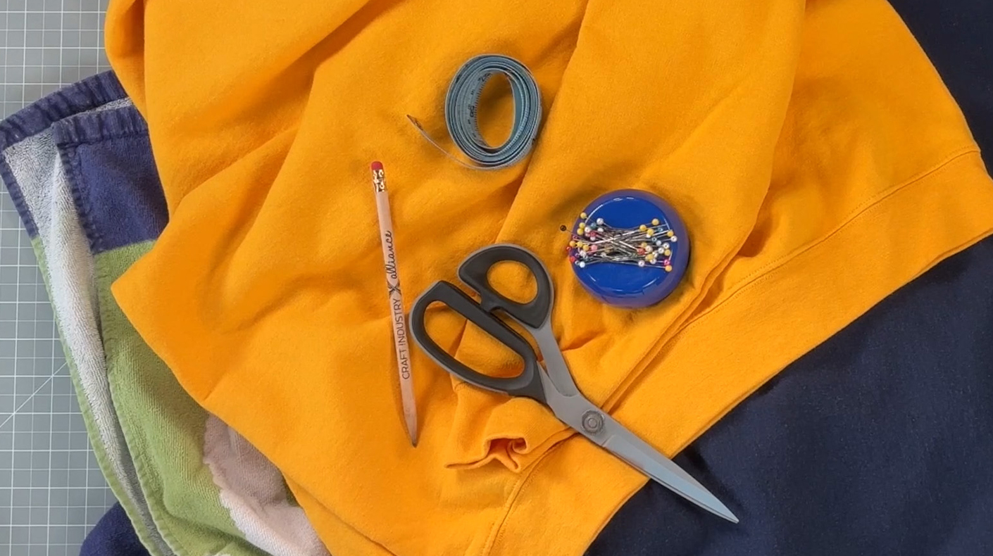 A few supplies including scissors, pencil, measuring tape, and pins