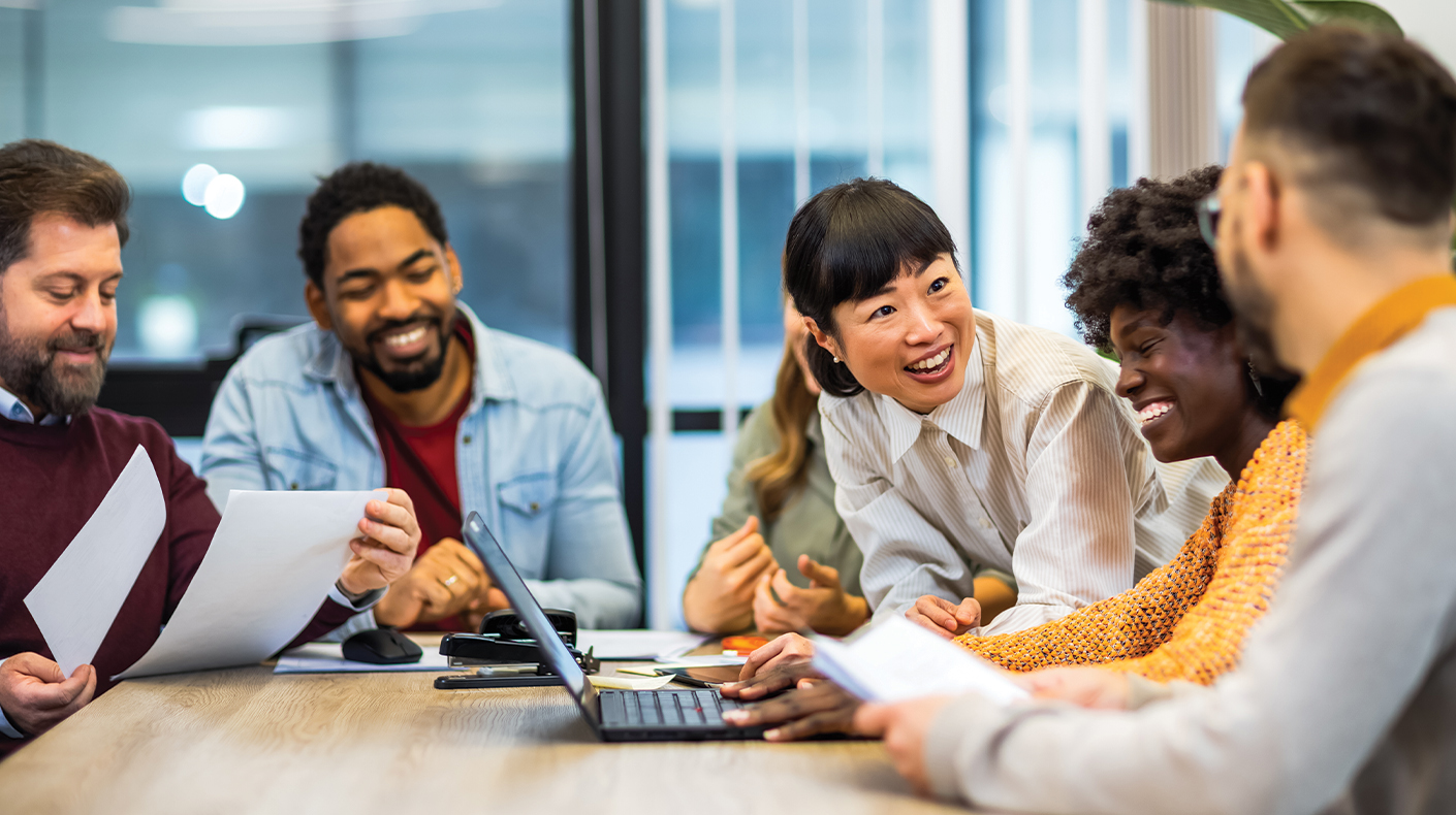 A group of people laughing during a meeting