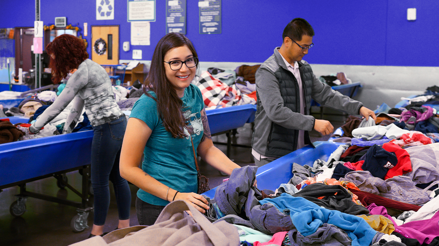 woman shopping in goodwill outlet bins