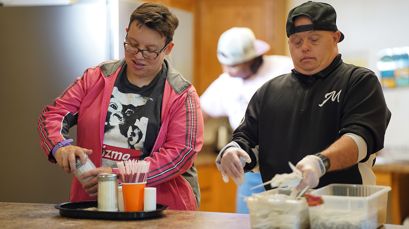 Two people prepping food service items - Day Services programs