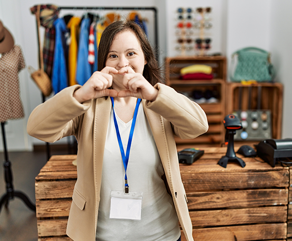 Retail employee with a disability making heart hands