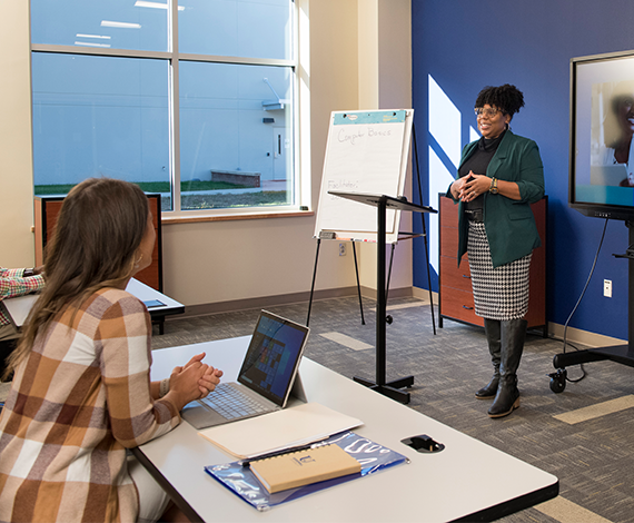 woman speaking at the front of a job training session